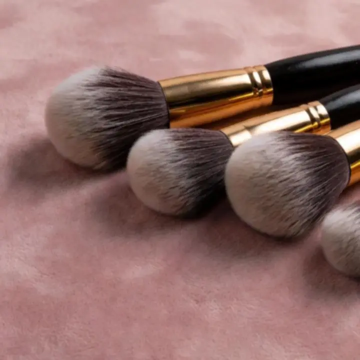 Close-up of professional makeup brushes with soft bristles arranged in a refined layout